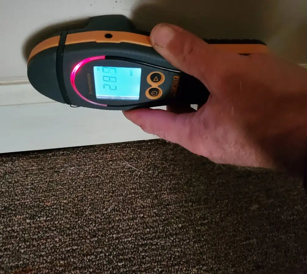 Moisture detection at baseboard during Storm Damage Restoration in Bedminster
